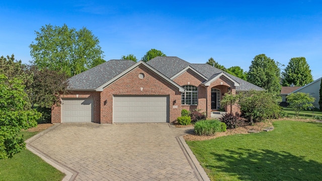 6599 Hartwig Dr, Cherry Valley, IL 61016 - view of front of property with an attached garage, a front yard, brick siding, and driveway