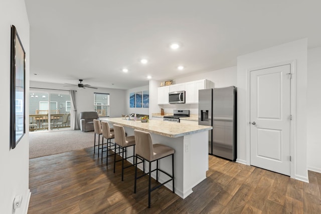 846 Briar Glen Ct, Hampshire, IL 60140 - kitchen featuring appliances with stainless steel finishes, white cabinets, an island with sink, a breakfast bar area, and light countertops