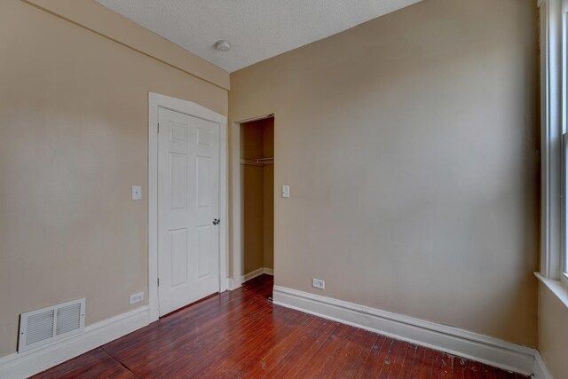 1837 S 50th Ct, Cicero, IL 60804 - unfurnished bedroom featuring dark wood-type flooring and baseboards