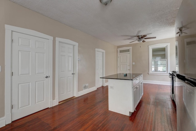 1837 S 50th Ct, Cicero, IL 60804 - kitchen with a ceiling fan, dark wood-type flooring, a textured ceiling, and a center island