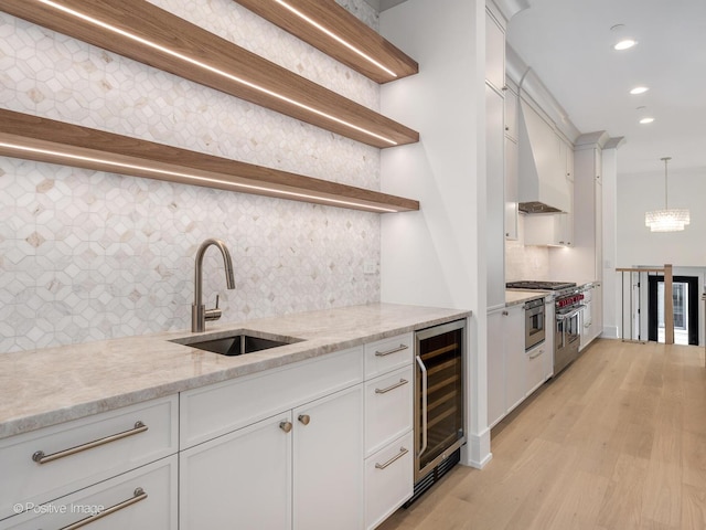 1853 W Barry Ave, Chicago, IL 60657 - kitchen with open shelves, wine cooler, a sink, high end stainless steel range, and decorative backsplash
