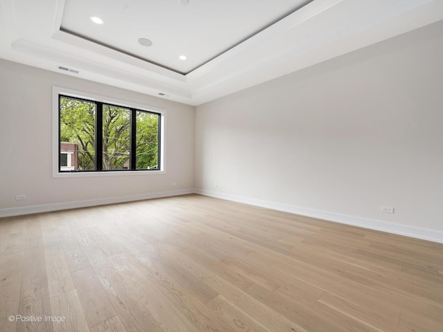 1853 W Barry Ave, Chicago, IL 60657 - spare room with light wood finished floors, baseboards, a tray ceiling, and recessed lighting