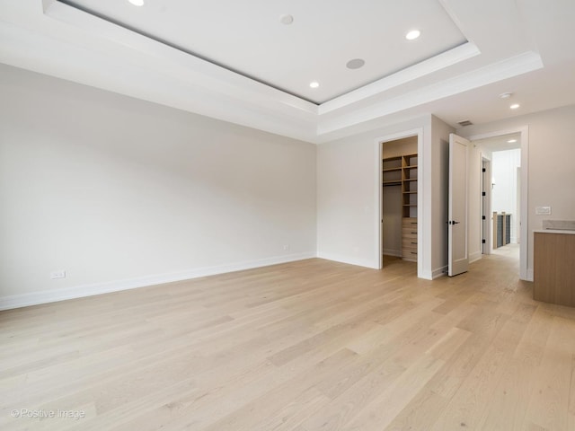 1853 W Barry Ave, Chicago, IL 60657 - spare room featuring a tray ceiling, recessed lighting, light wood-style flooring, and baseboards