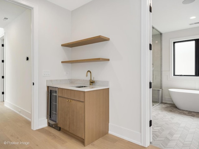 1853 W Barry Ave, Chicago, IL 60657 - indoor wet bar featuring beverage cooler, light wood-style flooring, baseboards, and recessed lighting