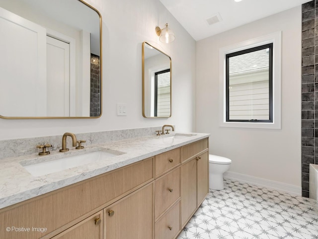 1853 W Barry Ave, Chicago, IL 60657 - full bathroom with double vanity, toilet, tile patterned floors, and baseboards