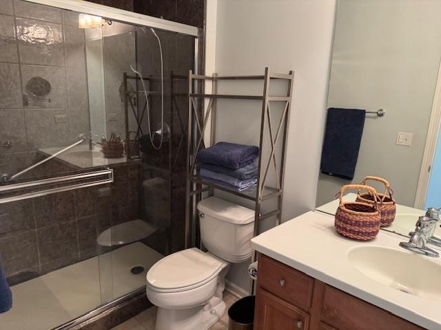 3881 Melody St, Mundelein, IL 60060 - full bathroom with toilet, vanity, a shower stall, and tile patterned flooring