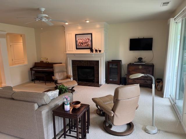 3881 Melody St, Mundelein, IL 60060 - carpeted living area with a tiled fireplace and a ceiling fan