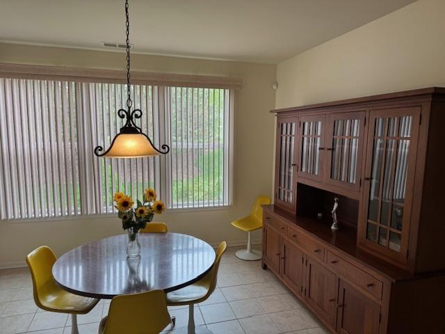 3881 Melody St, Mundelein, IL 60060 - dining space with light tile patterned flooring, plenty of natural light, and baseboards