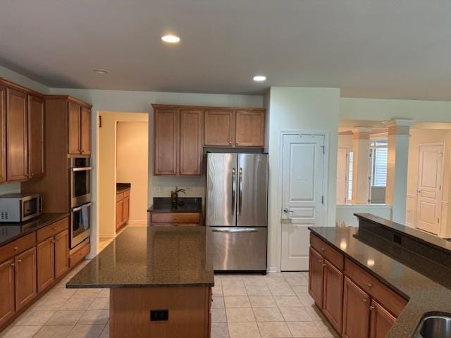 3881 Melody St, Mundelein, IL 60060 - kitchen with appliances with stainless steel finishes, a center island, dark stone counters, recessed lighting, and brown cabinetry