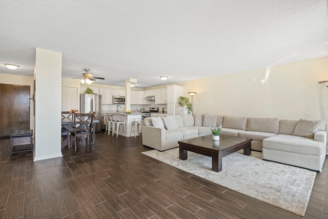 2211 S Highland Ave Unit 1B, Lombard, IL 60148 - living area with dark wood-style floors, a ceiling fan, and a textured ceiling