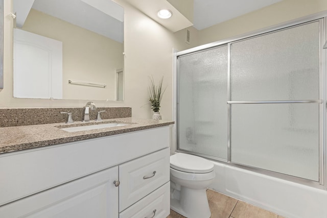 2211 S Highland Ave Unit 1B, Lombard, IL 60148 - bathroom with toilet, vanity, tile patterned flooring, and bath / shower combo with glass door