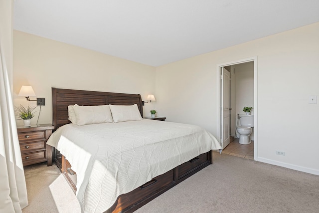 2211 S Highland Ave Unit 1B, Lombard, IL 60148 - bedroom with light colored carpet, baseboards, and ensuite bathroom