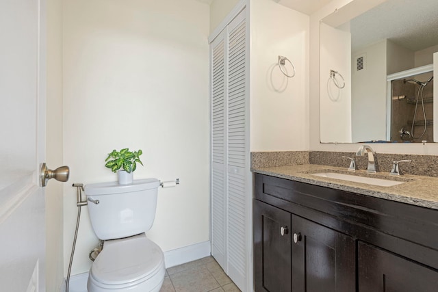 2211 S Highland Ave Unit 1B, Lombard, IL 60148 - bathroom featuring a closet, toilet, vanity, and tile patterned floors
