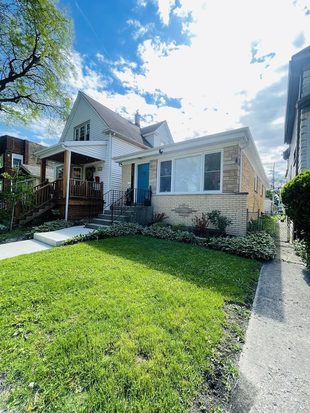 4634 N Hamlin Ave, Chicago, IL 60625 - bungalow with brick siding, a front yard, and covered porch