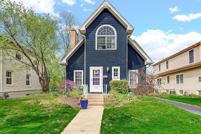 4204 Forest Ave, Western Springs, IL 60558 - view of front of house with a front lawn, a chimney, and central AC
