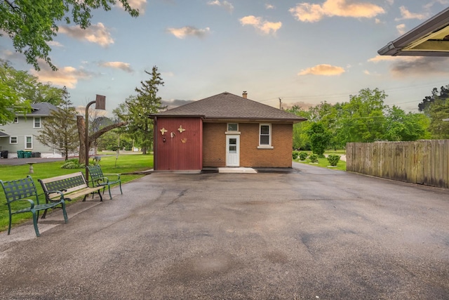 408 Manhattan Rd, Joliet, IL 60433 - exterior space with brick siding, a shingled roof, and a chimney