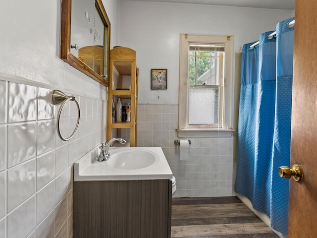 408 Manhattan Rd, Joliet, IL 60433 - full bath featuring tile walls, vanity, wood finished floors, curtained shower, and wainscoting
