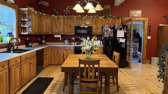 403 E Hickory St, Fairbury, IL 61739 - kitchen with black appliances, a sink, a chandelier, butcher block countertops, and light wood-style floors