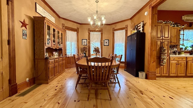 403 E Hickory St, Fairbury, IL 61739 - dining area featuring a chandelier, light wood-type flooring, and ornamental molding
