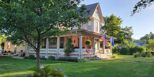 403 E Hickory St, Fairbury, IL 61739 - view of front facade featuring covered porch, a front lawn, and a shingled roof