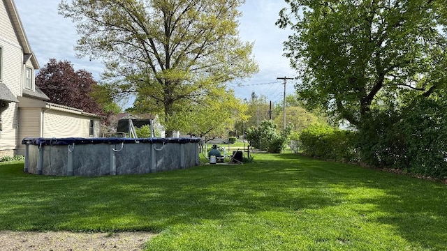 403 E Hickory St, Fairbury, IL 61739 - view of grassy yard with a covered pool