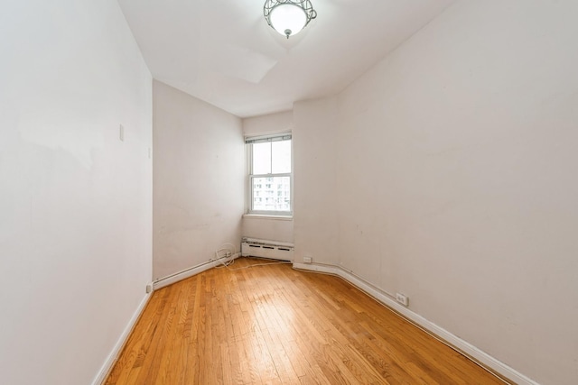 5555 N Sheridan Rd Unit 308, Chicago, IL 60640 - empty room featuring baseboard heating, light wood-type flooring, and baseboards