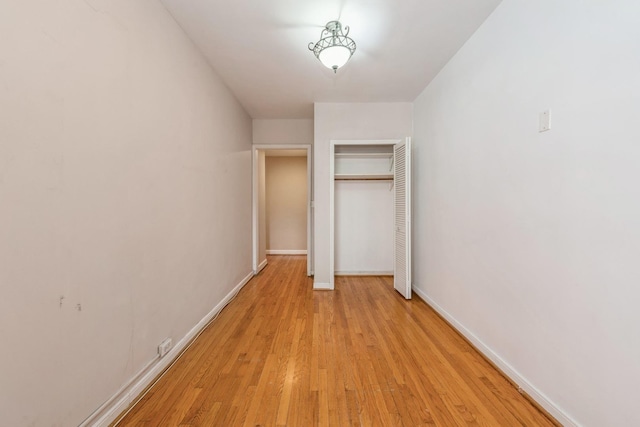 5555 N Sheridan Rd Unit 308, Chicago, IL 60640 - unfurnished bedroom featuring a closet, baseboards, and light wood-style floors