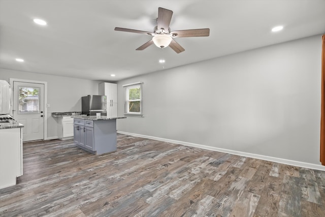 1011 Cypress Ln, Joliet, IL 60435 - kitchen featuring a ceiling fan, a kitchen island, light stone countertops, wood finished floors, and recessed lighting