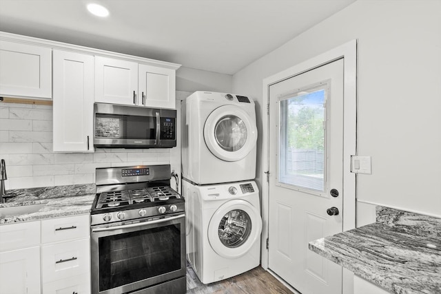 1011 Cypress Ln, Joliet, IL 60435 - laundry area with stacked washing machine and dryer and wood finished floors