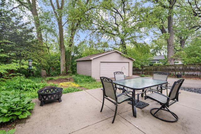 1000 Meadow Rd, Northbrook, IL 60062 - view of patio featuring a fire pit, outdoor dining area, an outdoor structure, and a detached garage
