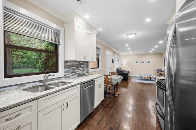 1000 Meadow Rd, Northbrook, IL 60062 - kitchen featuring appliances with stainless steel finishes, a sink, crown molding, white cabinets, and dark wood finished floors