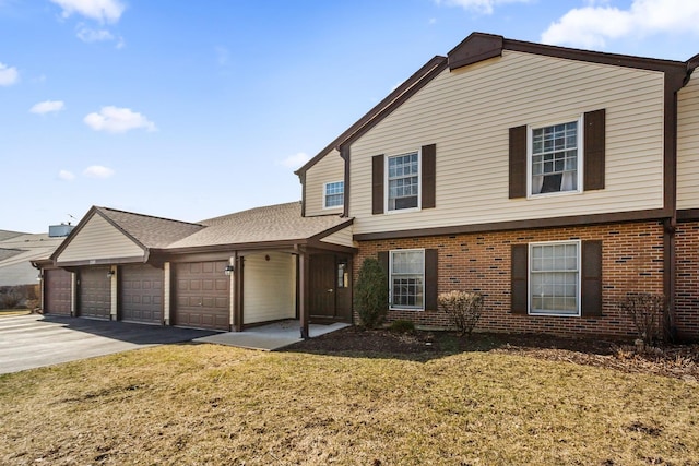 2165 Sunderland Ct Unit 101A, Naperville, IL 60565 - view of front of property featuring brick siding, a garage, asphalt driveway, and a front yard