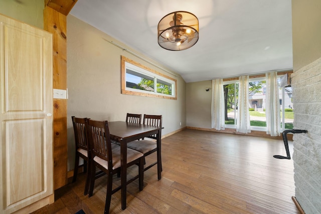 522 Division St, Pecatonica, IL 61063 - dining area featuring healthy amount of natural light, wood finished floors, a chandelier, baseboards, and vaulted ceiling