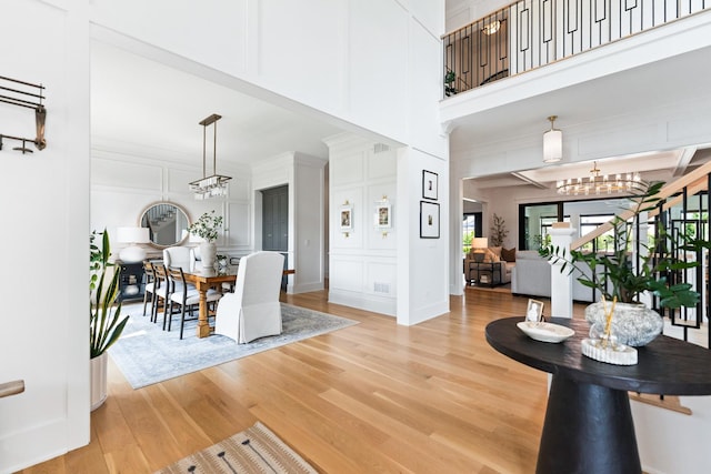 5N257 Switchgrass Ln, Saint Charles, IL 60175 - living area with a decorative wall, light wood-type flooring, healthy amount of natural light, stairway, and a towering ceiling