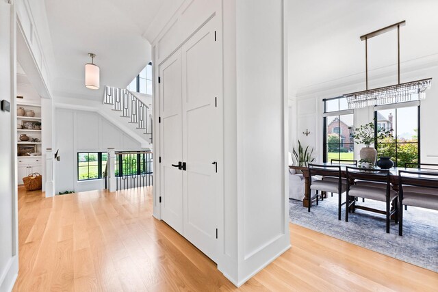 5N257 Switchgrass Ln, Saint Charles, IL 60175 - corridor featuring light wood finished floors, healthy amount of natural light, stairs, and a towering ceiling