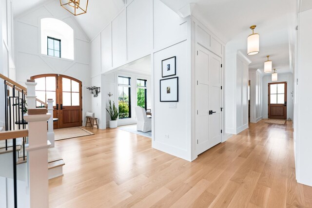 5N257 Switchgrass Ln, Saint Charles, IL 60175 - entryway with plenty of natural light, arched walkways, light wood-style floors, stairs, and high vaulted ceiling