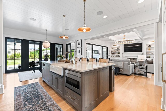 5N257 Switchgrass Ln, Saint Charles, IL 60175 - kitchen with stainless steel microwave, light countertops, light wood finished floors, hanging light fixtures, and recessed lighting