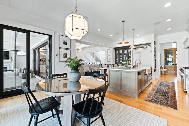 5N257 Switchgrass Ln, Saint Charles, IL 60175 - dining space featuring stairway, light wood-style floors, recessed lighting, and a fireplace