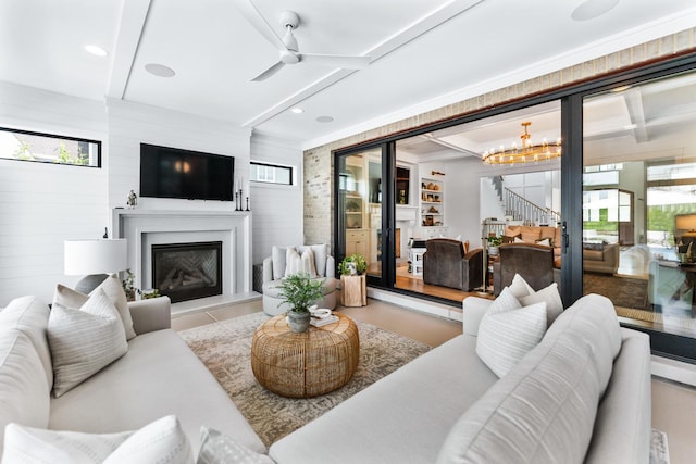 5N257 Switchgrass Ln, Saint Charles, IL 60175 - living area with a glass covered fireplace, stairway, beam ceiling, ceiling fan, and a chandelier