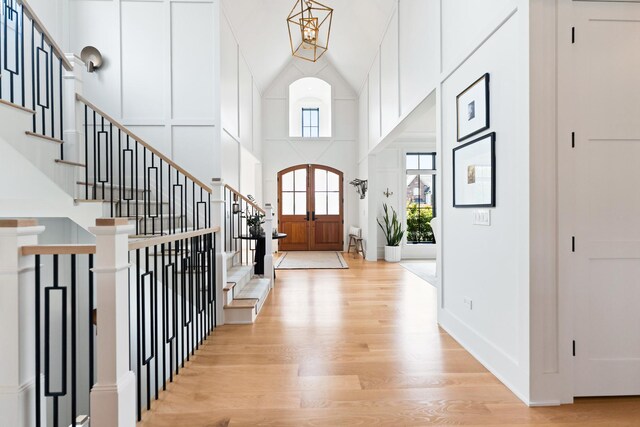 5N257 Switchgrass Ln, Saint Charles, IL 60175 - staircase featuring wood finished floors, a chandelier, coffered ceiling, beamed ceiling, and a fireplace