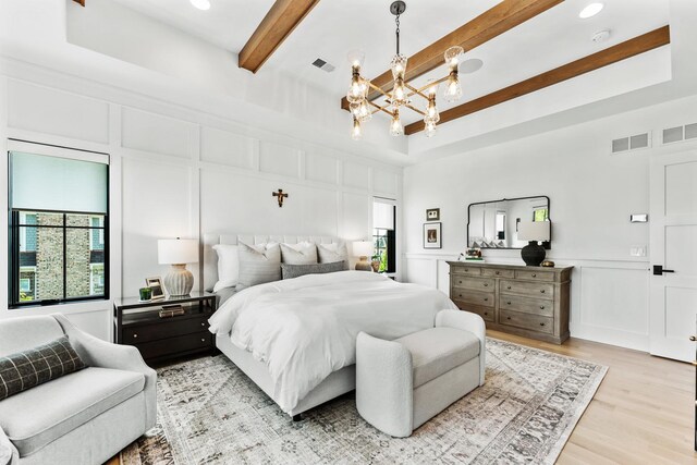 5N257 Switchgrass Ln, Saint Charles, IL 60175 - bedroom with a decorative wall, a chandelier, light wood-style floors, beamed ceiling, and a tray ceiling