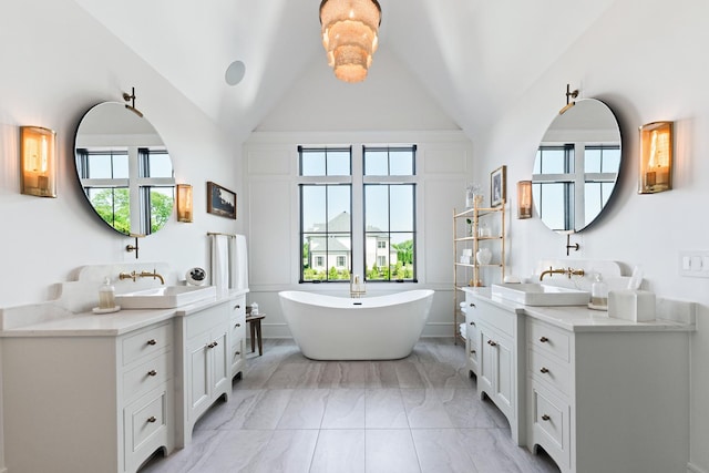 5N257 Switchgrass Ln, Saint Charles, IL 60175 - full bath featuring two vanities, healthy amount of natural light, a freestanding bath, lofted ceiling, and marble look tiles