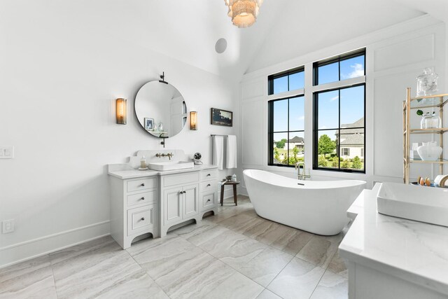 5N257 Switchgrass Ln, Saint Charles, IL 60175 - full bath featuring two vanities, healthy amount of natural light, a soaking tub, lofted ceiling, and marble finish flooring
