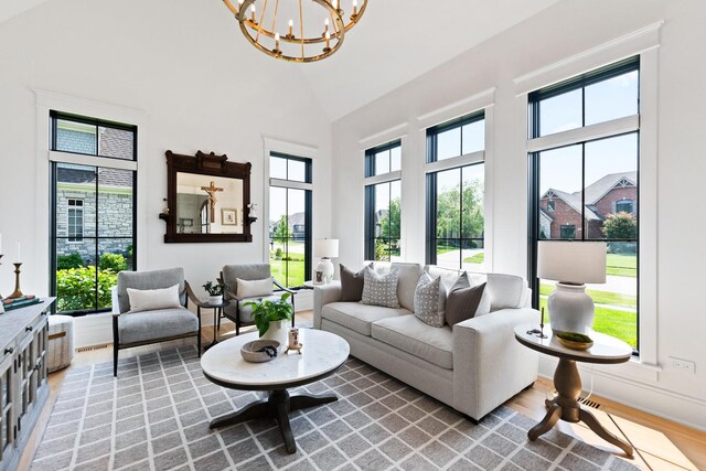 5N257 Switchgrass Ln, Saint Charles, IL 60175 - living room featuring light wood-style floors, high vaulted ceiling, and a chandelier