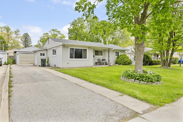 8 Sparrow Rd, Carpentersville, IL 60110 - view of front facade featuring a front yard and a detached garage
