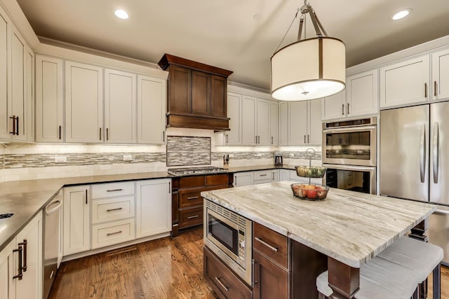 212 S Wa Pella Ave, Mount Prospect, IL 60056 - kitchen with appliances with stainless steel finishes, recessed lighting, tasteful backsplash, dark wood-style floors, and hanging light fixtures