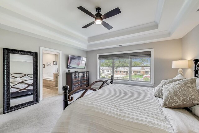 212 S Wa Pella Ave, Mount Prospect, IL 60056 - carpeted bedroom featuring a tray ceiling, ensuite bathroom, and ceiling fan