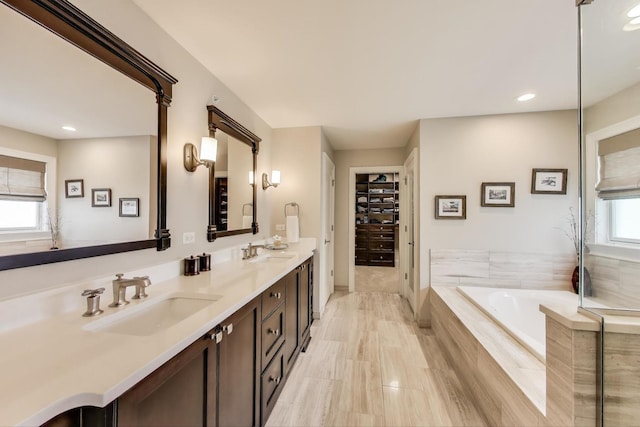 212 S Wa Pella Ave, Mount Prospect, IL 60056 - full bathroom with double vanity, a garden tub, recessed lighting, and a walk in closet