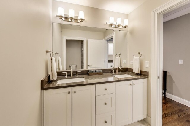 212 S Wa Pella Ave, Mount Prospect, IL 60056 - bathroom featuring double vanity, wood finished floors, and baseboards