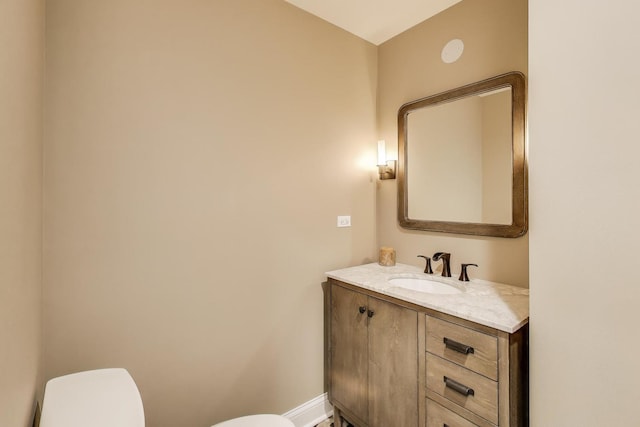212 S Wa Pella Ave, Mount Prospect, IL 60056 - bathroom featuring toilet, vanity, and baseboards